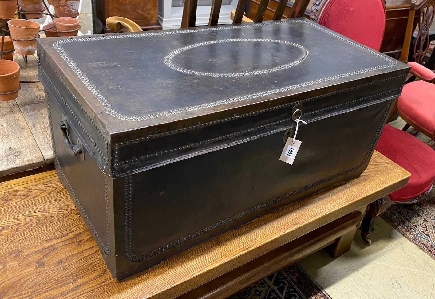 An early 19th century brass mounted studded black leather trunk, length 92cm, depth 46cm, height 42cm